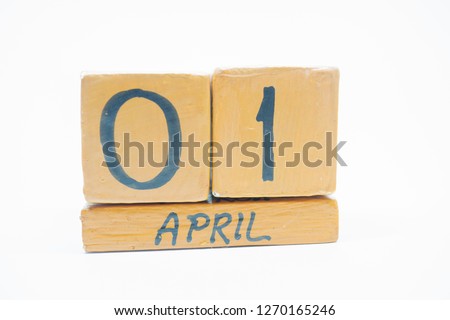 April 1st. Day 1 of month, handmade wood calendar isolated on white background. spring month, day of the year concept