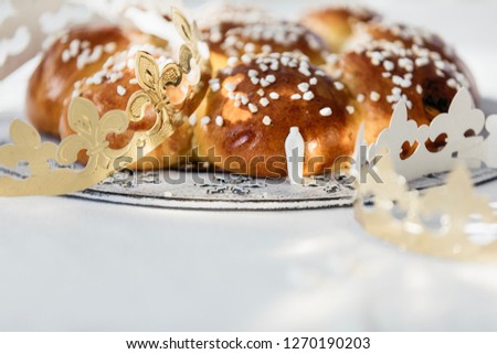 King Bread, called in German language Dreikönigskuchen, baked in Switzerland on January 6th. Small plastic miniature of the king is hidden inside of the bread. The person who finds it, is the king.
