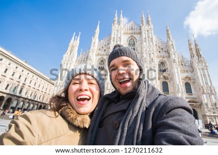 Couple taking self portrait in Duomo square in Milan. Winter holidays, traveling and relationship concept