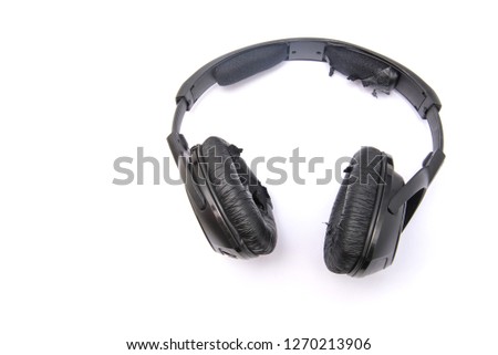 Old earphones on a white backgroundworn headphones