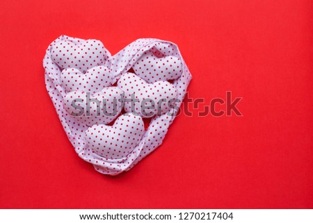 Red dots on white heart shape, Valentine's hearts on red background, Top view with copy space