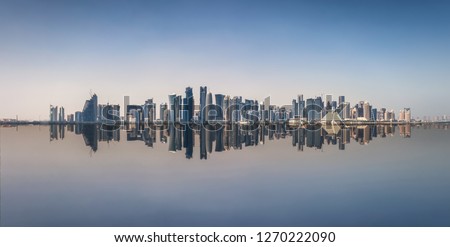The iconic skyline of Doha, Qatar, with the modern skyscrapers with reflections on the sea Royalty-Free Stock Photo #1270222090