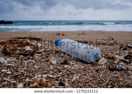 Trash, plastic, garbage, bottle... environmental pollution on the beach. Royalty high-quality free stock photo image of trash, plastic bottle on the beach. Waste that polluted the ocean environment