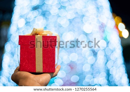 Man is holding a New year present. Gifts for men.Gift for a girl. - Image