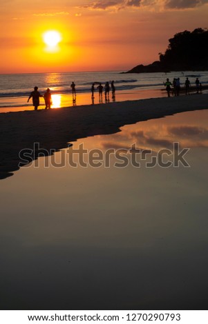 People at the beach in sundown