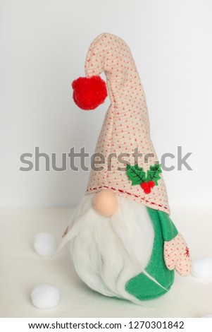 scandinavian swedish gnome in green clothes on a white background