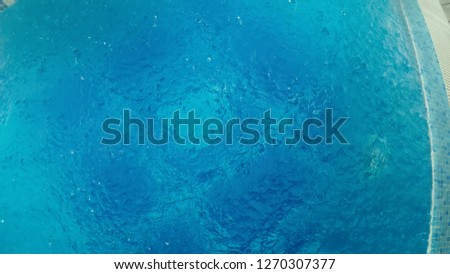 Large Drops of Rain fall in a Pool During a Rainstorm, aerial view