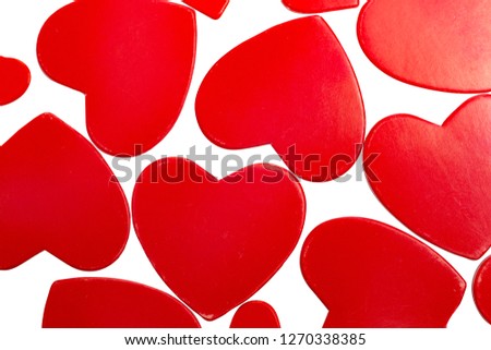 Photo of red hearts on a white background in the form of an abstract pattern top view
