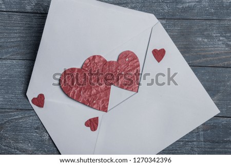 Valentines day greeting card. Handmaded hearts on wooden table. Love background