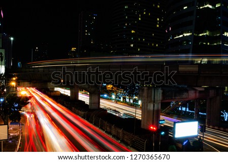 Car and skytrain light trails with slow shutter night shot in bangkok