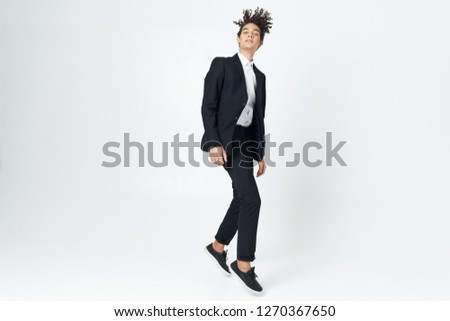 Man dancing on an isolated white background in a business suit