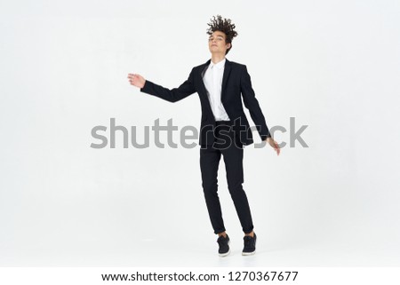 Man in business suit jumping on isolated background.