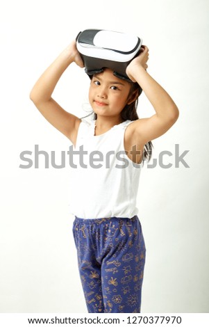 Cute girl having fun with virtual reality headset. Innovation technology and education concept. white background