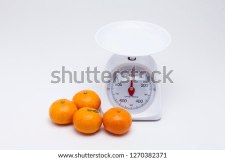 Healthy mandarin oranges on balance scale