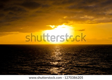 sunrise in the sea with colored clouds