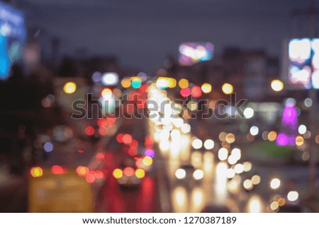 Abstract blur image of Road in Night time with bokeh for background usage blurred background. Night city lights blur. Retro toned photo, vintage tone.