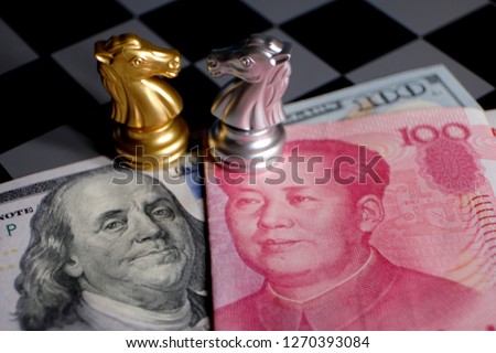 Chess game, two knights face to face on Chinese yuan and US dollar background. Trade way concept. Conflict between two big countries, USA and China concept. Copy space for text. Royalty-Free Stock Photo #1270393084