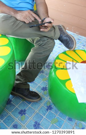 Men's feet sitting on a green chair