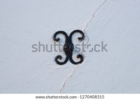Close up: Iron fixation for a crossbeam on the wall of an old traditional house on the North Sea Island Fanoe, Denmark