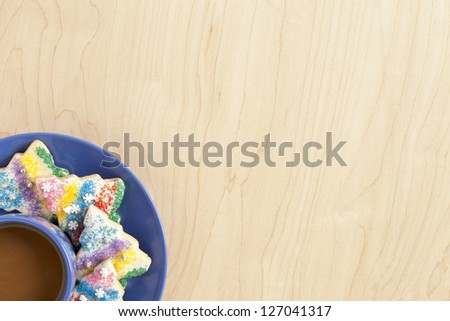 Cropped image of hot chocolate with colorful biscuits isolated on a wooden background