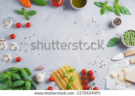 Italian food cooking ingredients. Pasta, vegetables, spices. Top view with copy space Royalty-Free Stock Photo #1270424095