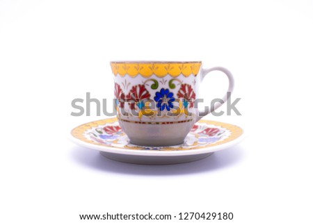 Turkish coffee in a white cup isolated on a motifed background (path included). Traditional Turkish Coffee