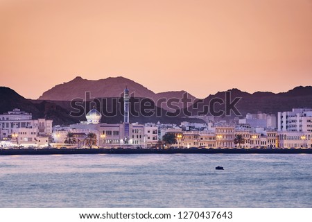 Cityscape view of Muscat city at golden sunset. The capital of Oman. Royalty-Free Stock Photo #1270437643