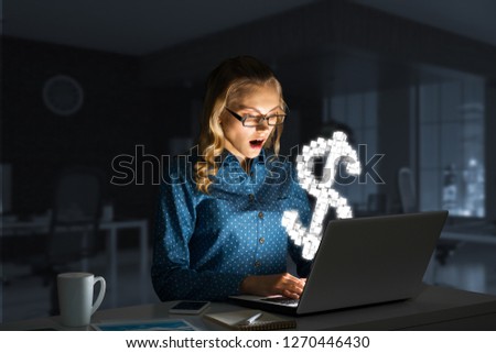 Surprised beautiful girl looking in glowing laptop screen. Mixed media