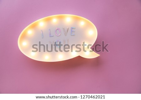 Creative Valentine Day romantic composition. flat lay love holiday celebration text I love you on lightbox on pink background with copy space