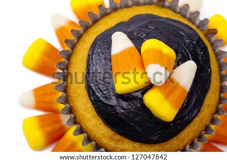Close-up of cupcake decorated with candy corn and chocolate cream