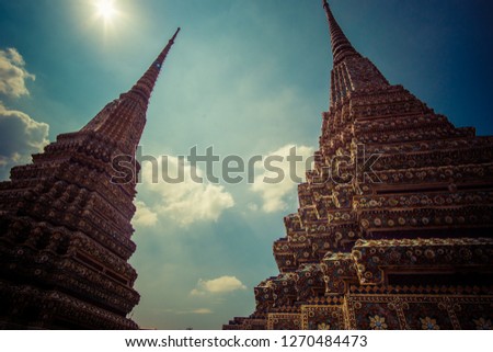 wat Pho themple in Bangkok, Thailand on sunny day outdoors.