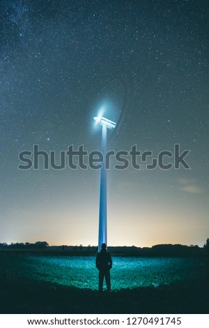 People shining at wind turbine