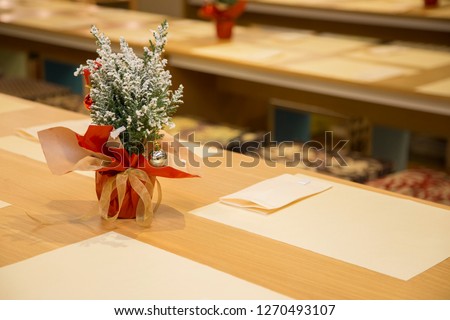 horizontal image with detail of a restaurant table prepared for two, in the evening with Christmas decorations
