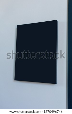 Black Signage board on the white wall in front of office door. Nameplate on white wall. Black signage on a white wall mockup