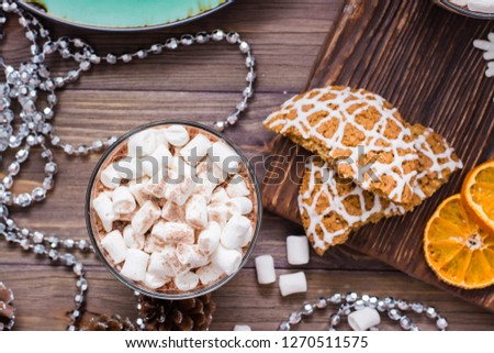 Hot cocoa with marshmallows and cinnamon in glasses on the table in Christmas decorations. Top view