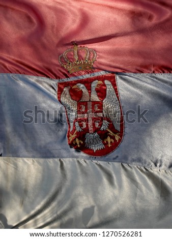 Used and faded Serbian flag