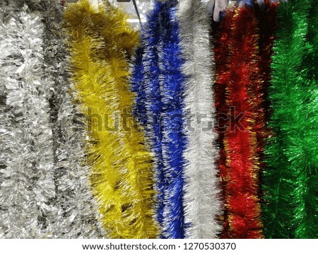 Festive shiny tinsel. Christmas decorations. Texture. Abstract background. Colorful pattern.
