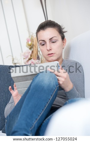 Close up of a cute woman using a tablet in her living room,Italy