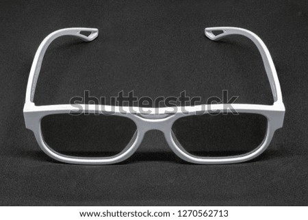 White 3 Dimensional glasses on a dark grey background