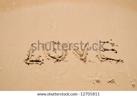 sign on the sand at a coastline