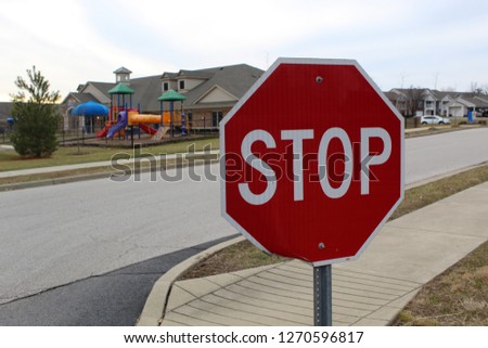 Stop sign in front of school playground