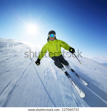Skier on piste in high mountains