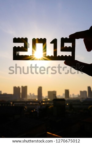 Happy new year 2019. Silhouette of 2019 brick number with city background in the morning.
