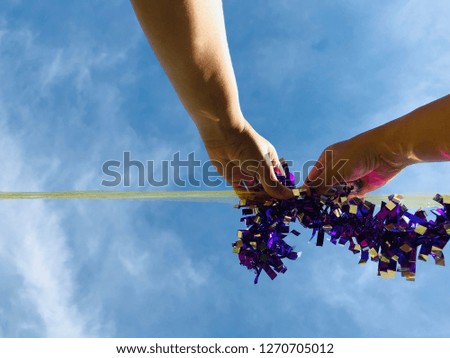 Organize party with hand made under the sky.Close up portrait of women hand decorating rainbow in party. 
