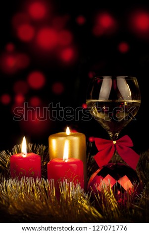Glass with champagne and burning candles