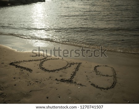 Happy New Year 2019 text on the beach 