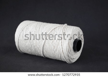 Natural string roll on a black background