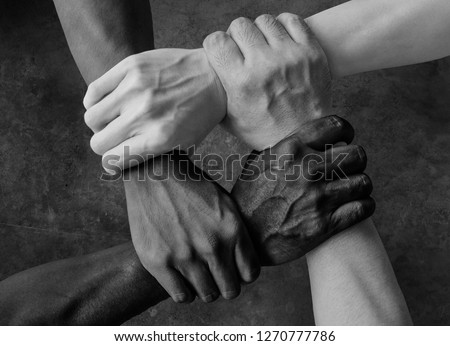 multiracial group with black african American Caucasian and Asian hands holding each other wrist in tolerance unity love and anti racism concept in black and white isolated background Royalty-Free Stock Photo #1270777786