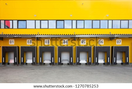 Seven truck loading docks at a distribution warehouse. Distribution hub for sorting packages and parcels.
