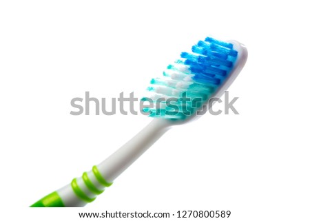 green toothbrush on an isolated background, close up